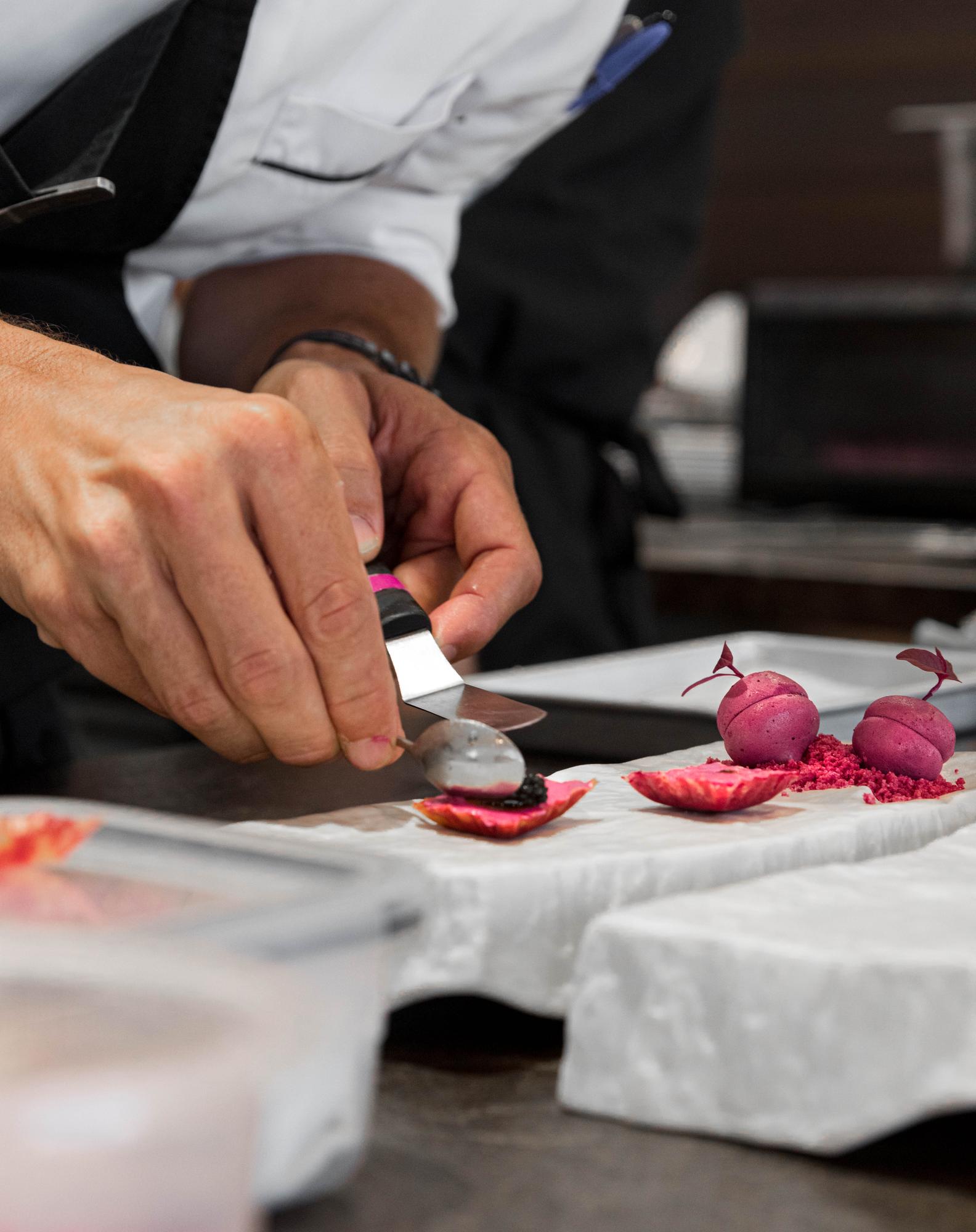Chef demonstrating knife technique to participants